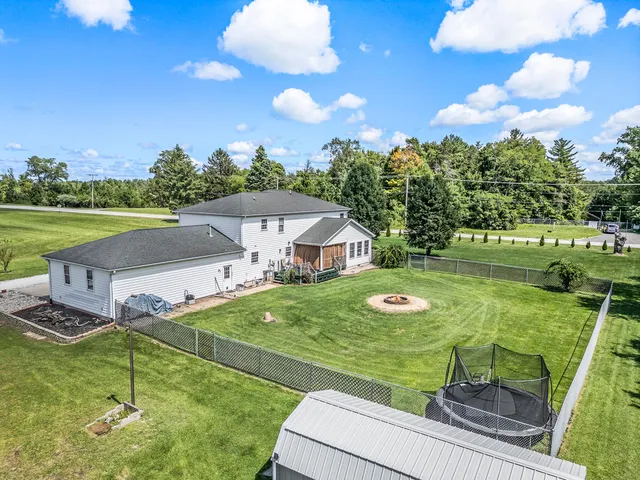 a view of a house with yard and swimming pool