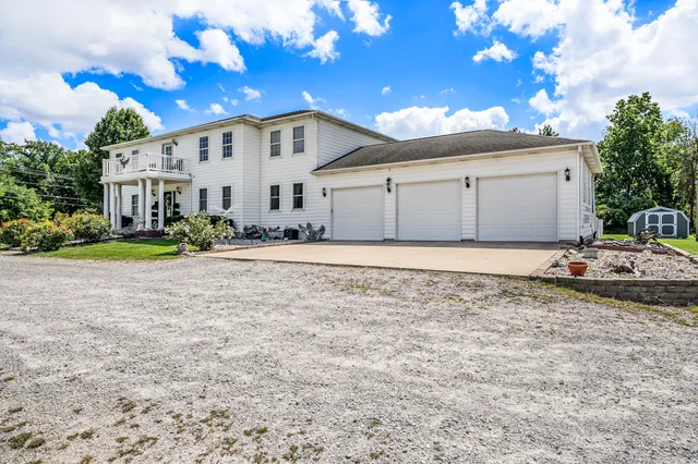 a view of a white house with a yard