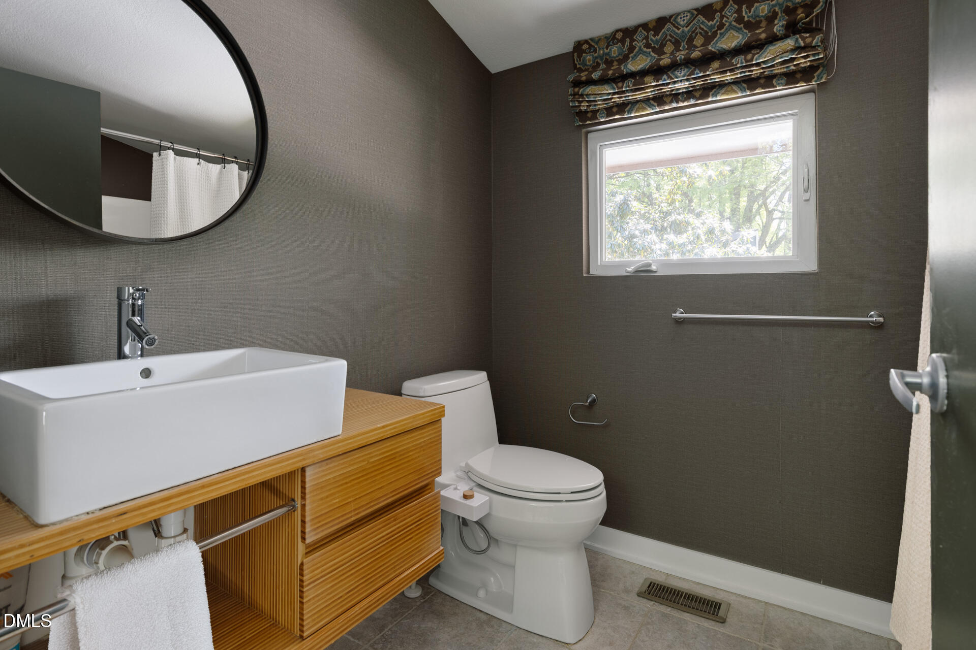5208 Saddle Court Raleigh, NC 27609 - Photo 37 of 43 a bathroom with a toilet a sink and mirror