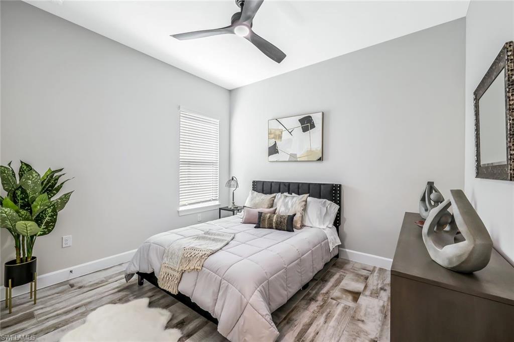 15495 Rio Ponace Court Naples, FL 34114 - Photo 17 of 43 Bedroom featuring wood finished floors and ceiling fan