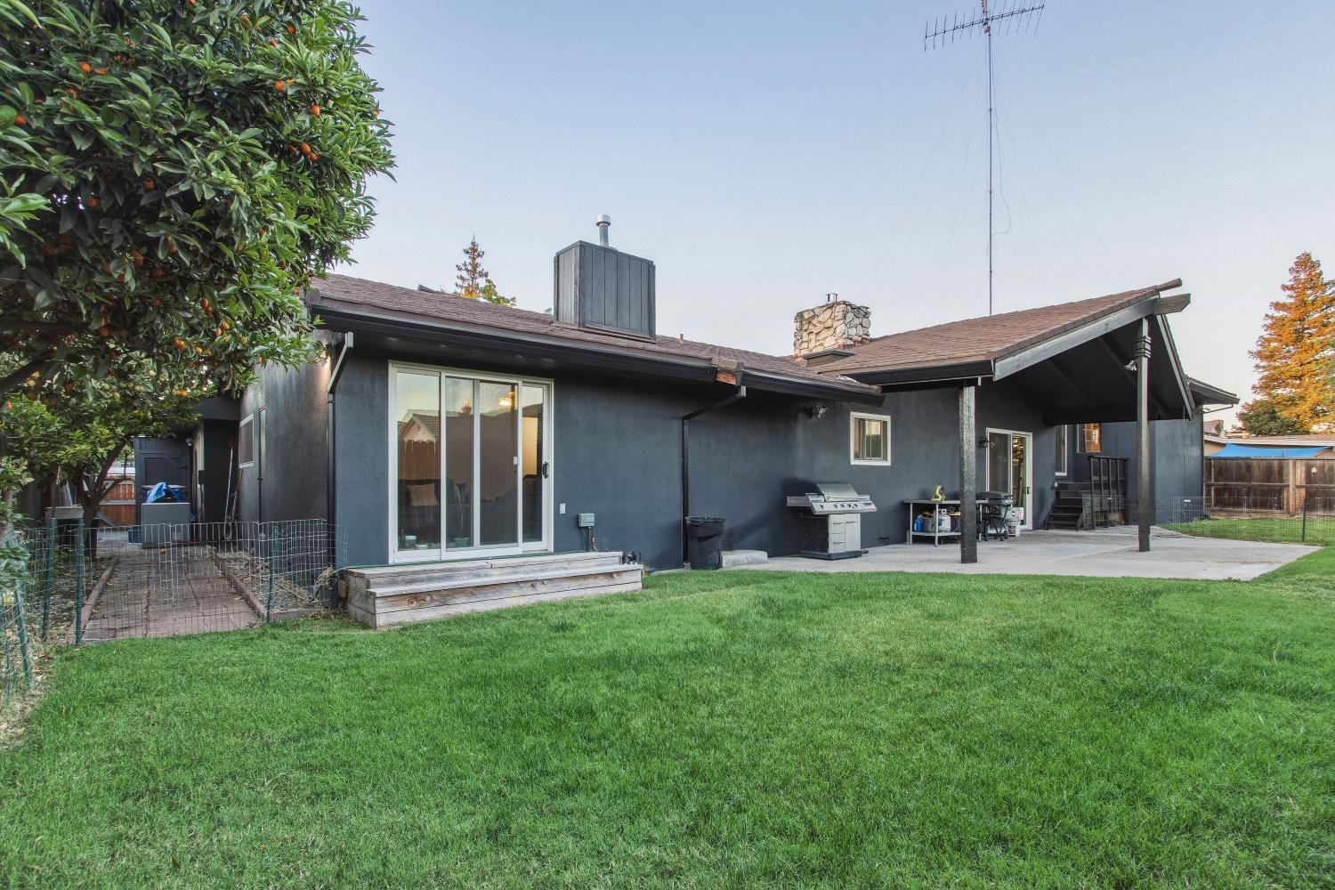 1908 Chelwood Way Modesto, CA 95355 - Photo 25 of 32 a front view of a house with a garden and patio