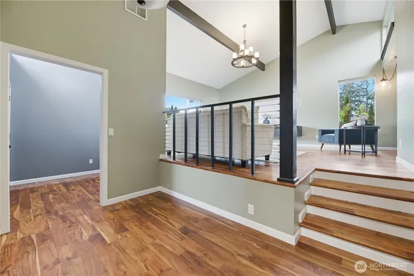 a view of staircase with white walls and a rug