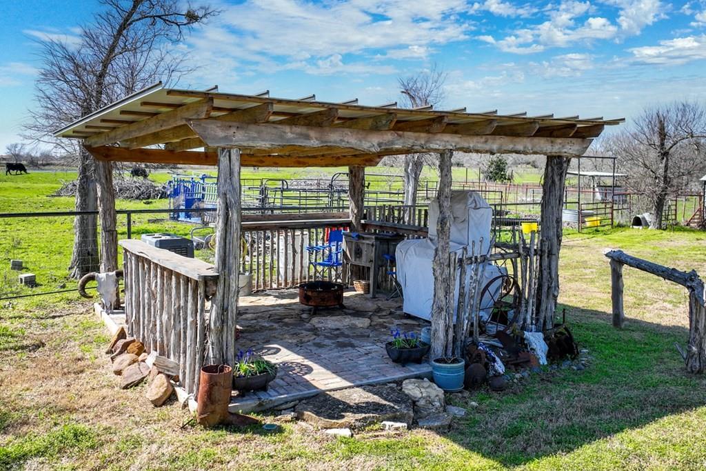 10276 Timber Trail Scurry, TX 75158 - Photo 35 of 40 a view of a patio with a table chairs and a yard