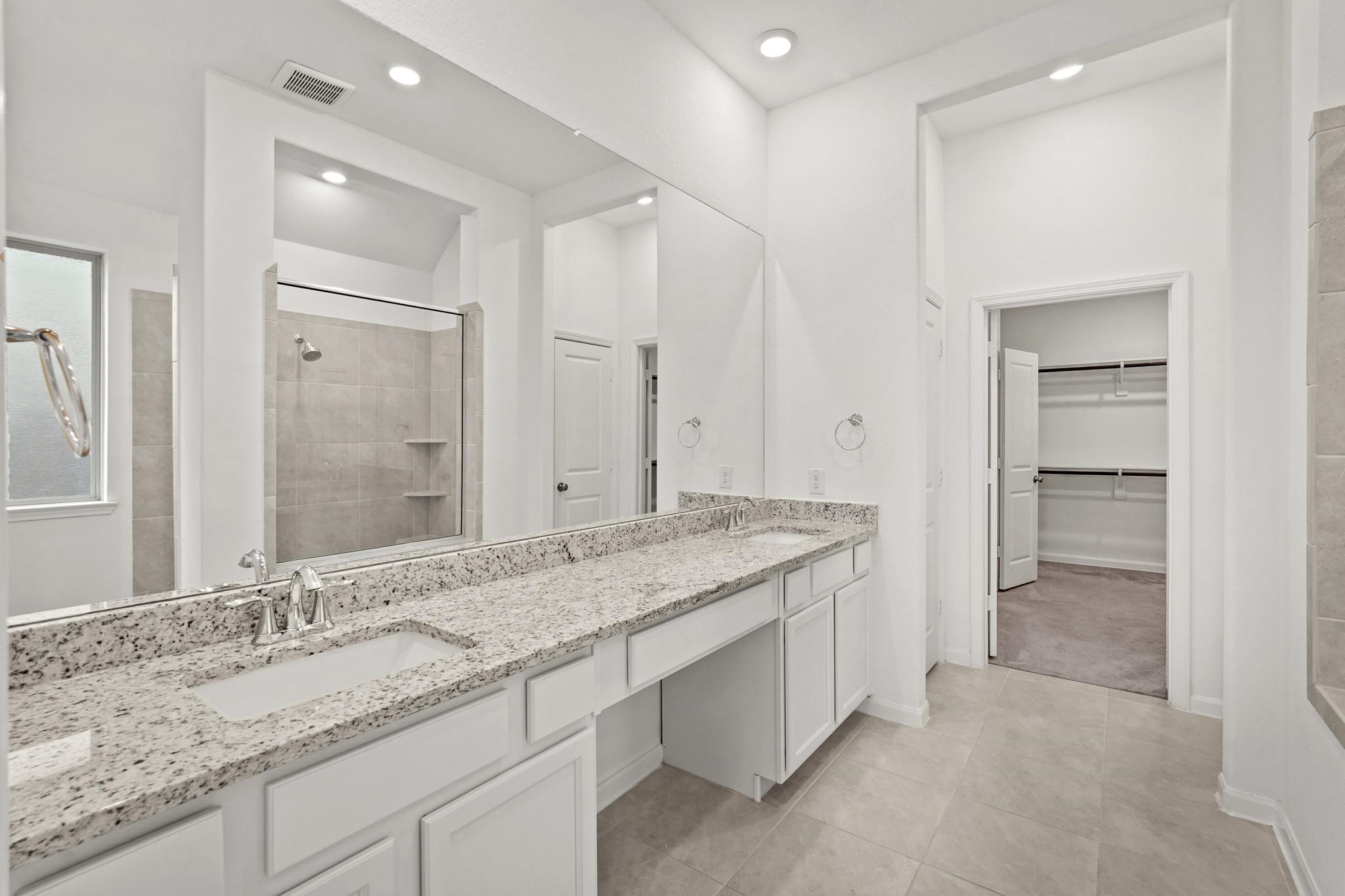 4915 Sierra Ridge Drive Rosenberg, TX 77469 - Photo 10 of 25 a bathroom with a granite countertop sink and a mirror