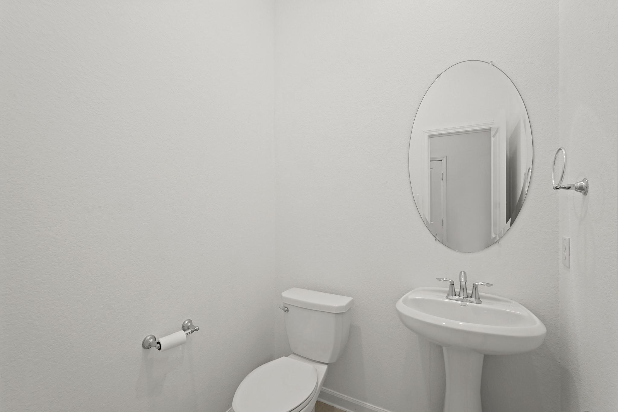 4915 Sierra Ridge Drive Rosenberg, TX 77469 - Photo 15 of 25 a bathroom with a toilet a sink and mirror