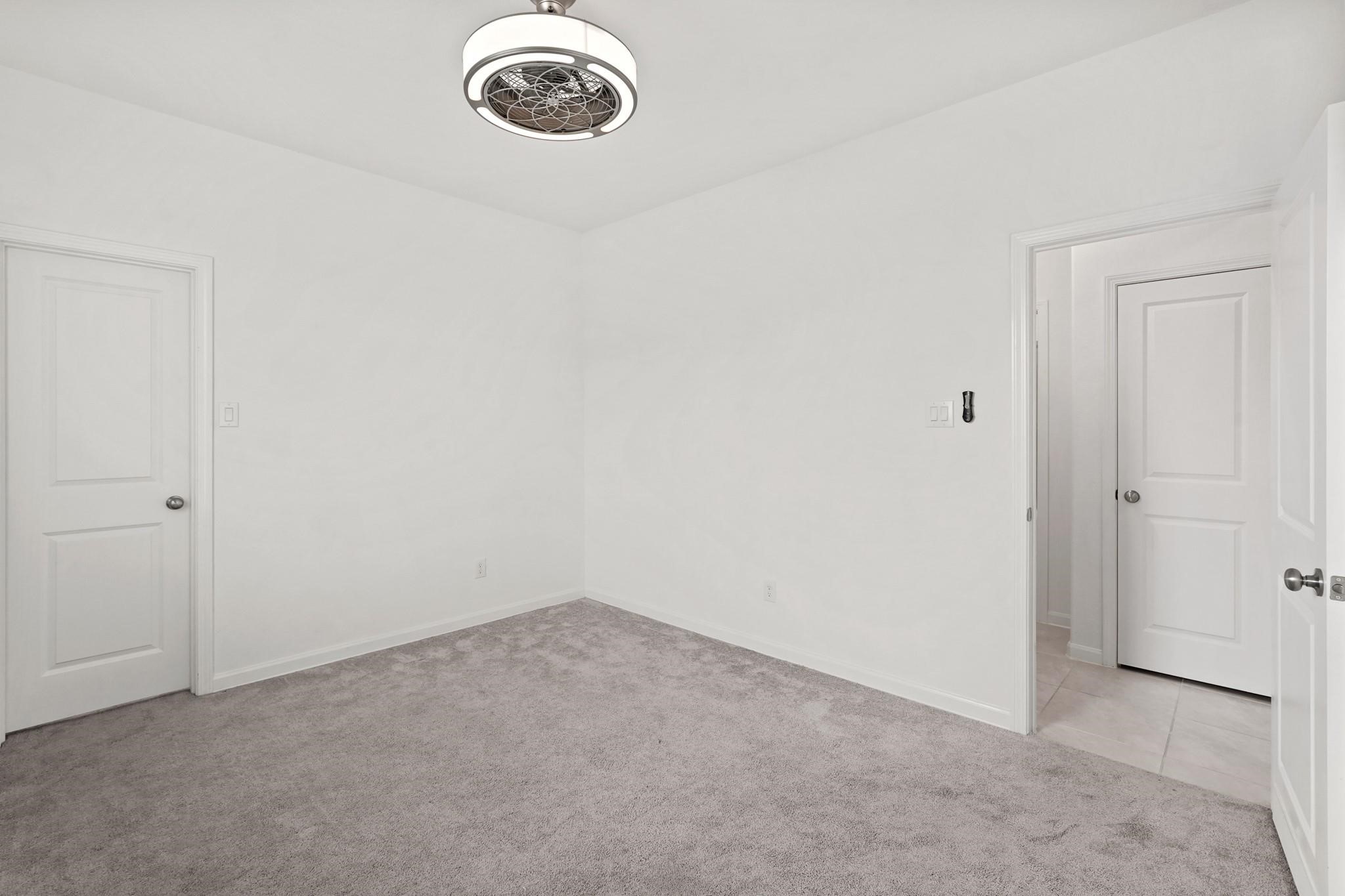 4915 Sierra Ridge Drive Rosenberg, TX 77469 - Photo 17 of 25 an empty room with a chandelier fan