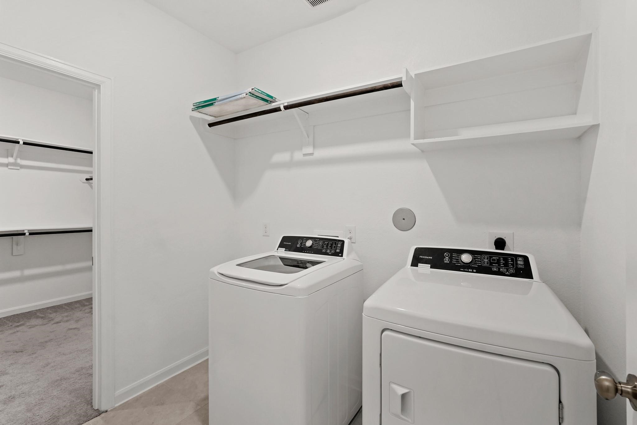4915 Sierra Ridge Drive Rosenberg, TX 77469 - Photo 21 of 25 a view of storage and utility room with washer and dryer