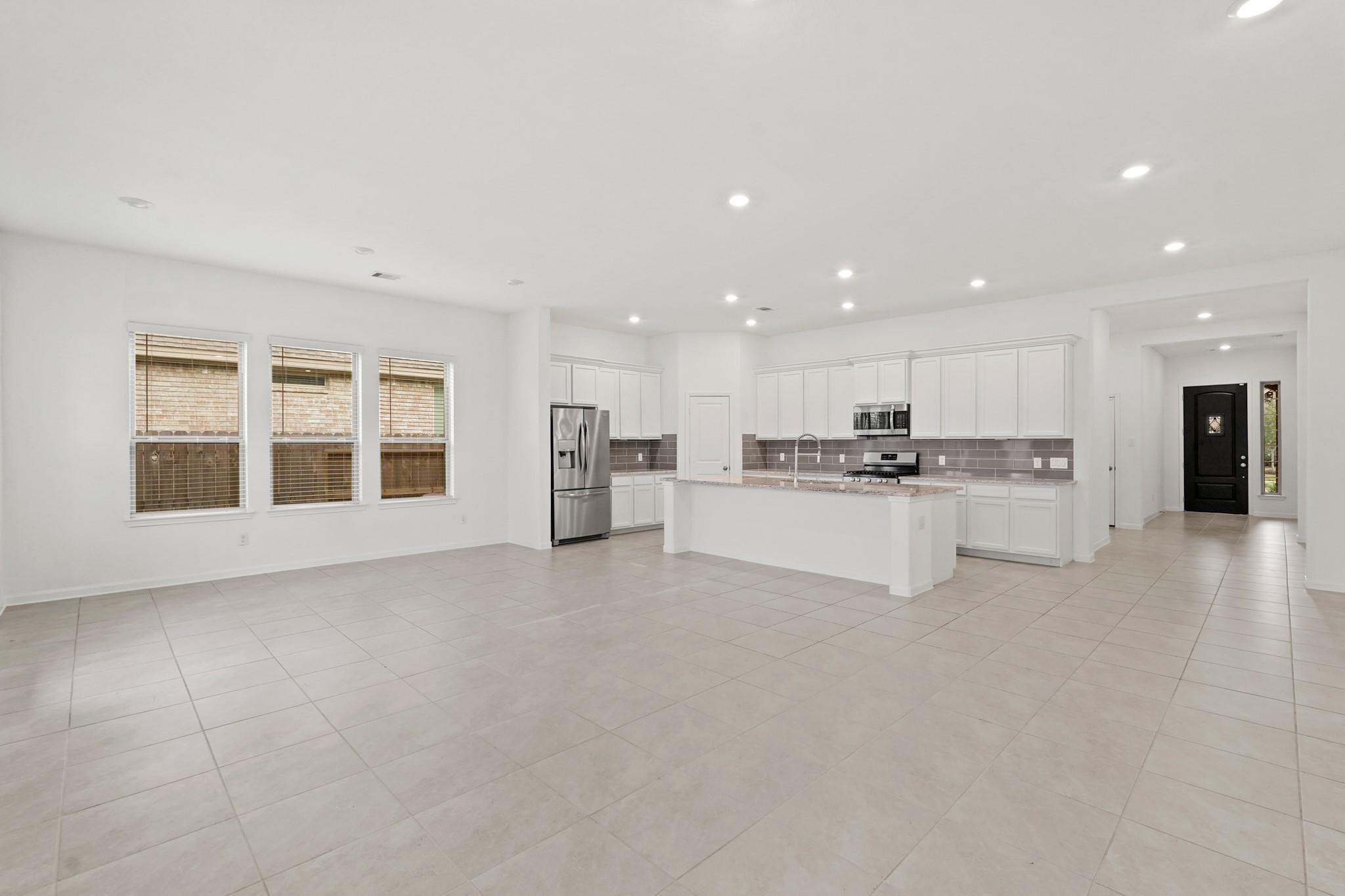 4915 Sierra Ridge Drive Rosenberg, TX 77469 - Photo 6 of 25 a view of kitchen with kitchen island and stainless steel appliances