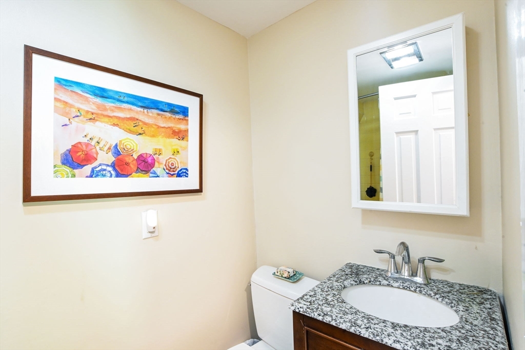 2 Jonathan Lane Sandwich, MA 02563 - Photo 22 of 38 a bathroom with a granite countertop sink a mirror and a picture on the wall