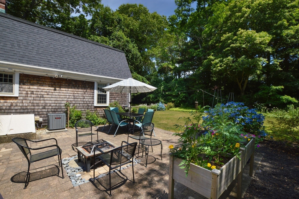 2 Jonathan Lane Sandwich, MA 02563 - Photo 27 of 38 a view of a patio with table and chairs and potted plants