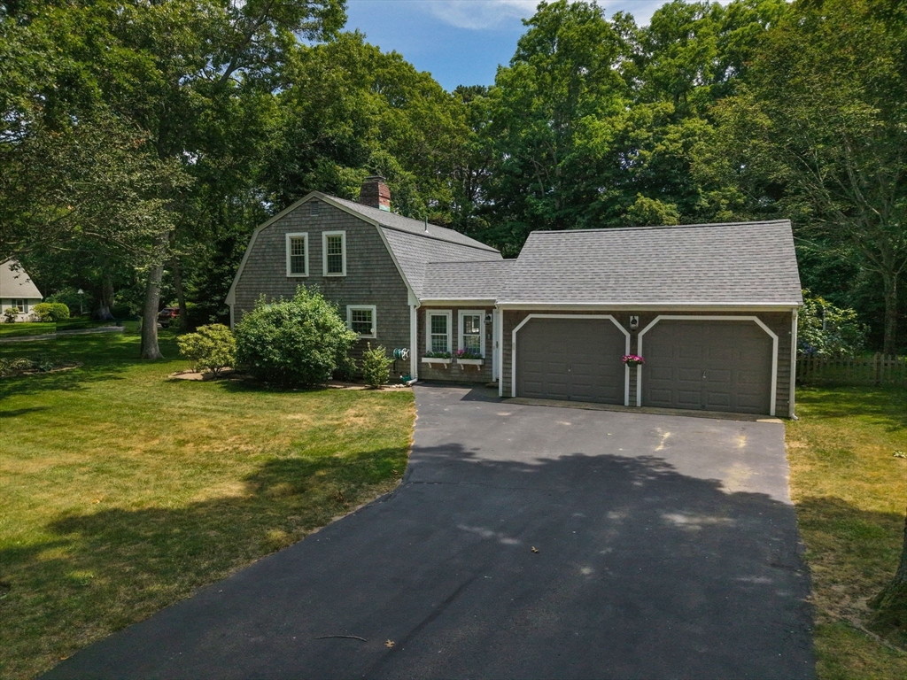 2 Jonathan Lane Sandwich, MA 02563 - Photo 3 of 38 a front view of a house with a yard and garage