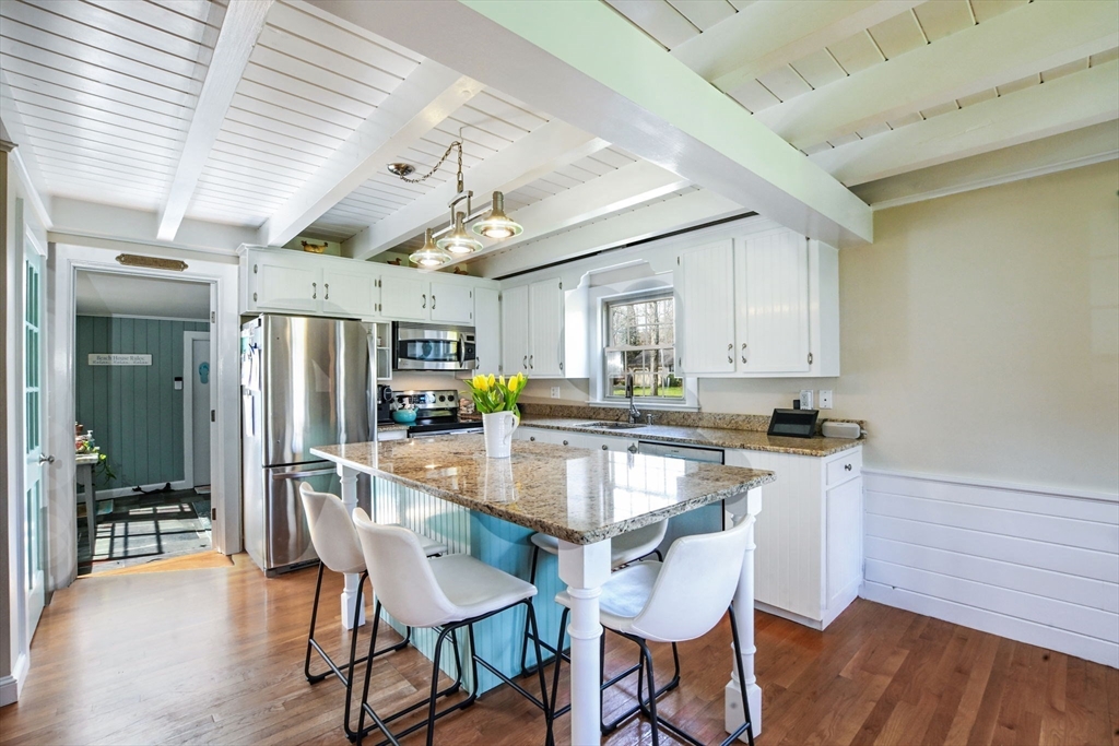 2 Jonathan Lane Sandwich, MA 02563 - Photo 8 of 38 a kitchen with stainless steel appliances kitchen island granite countertop a table chairs in it and wooden floors