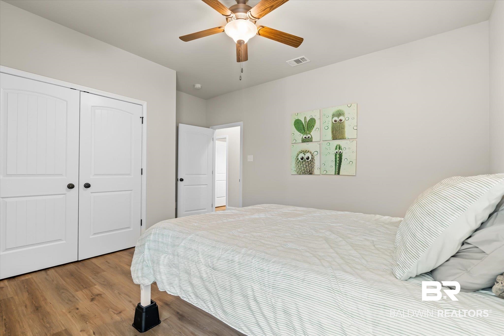 1116 Stella Road Foley, AL 36535 - Photo 17 of 29 Bedroom featuring ceiling fan, a closet, and hardwood / wood-style floors