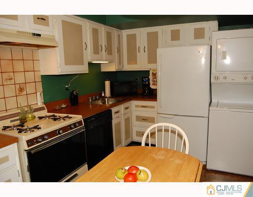 1919 Raspberry Court Edison, NJ 08817 - Photo 3 of 9 a kitchen with stainless steel appliances kitchen island granite countertop a refrigerator a stove a sink and white cabinets