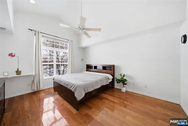 a spacious bedroom with a bed and a window