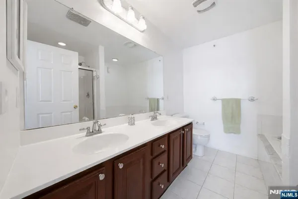 a bathroom with a sink double vanity and a mirror