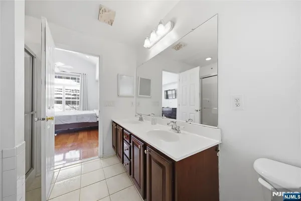 a bathroom with a sink a toilet a mirror and vanity