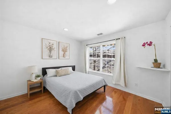 a bedroom with a bed and a window