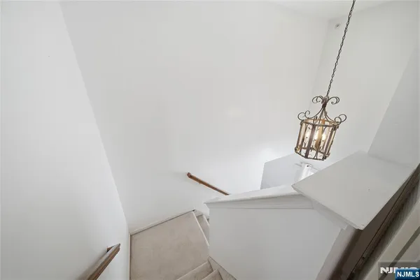 a view of staircase with rug