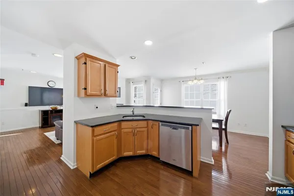 a kitchen with a sink cabinets and wooden floor