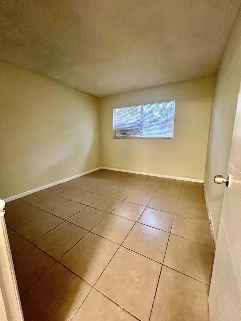 645 Southwest 20th Court, Unit 20 Delray Beach, FL 33445 - Photo 11 of 18 a view of a room with an empty space and a window