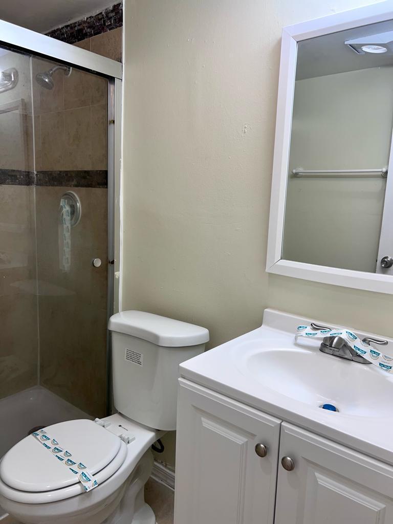 645 Southwest 20th Court, Unit 20 Delray Beach, FL 33445 - Photo 14 of 18 a bathroom with a sink a toilet and shower
