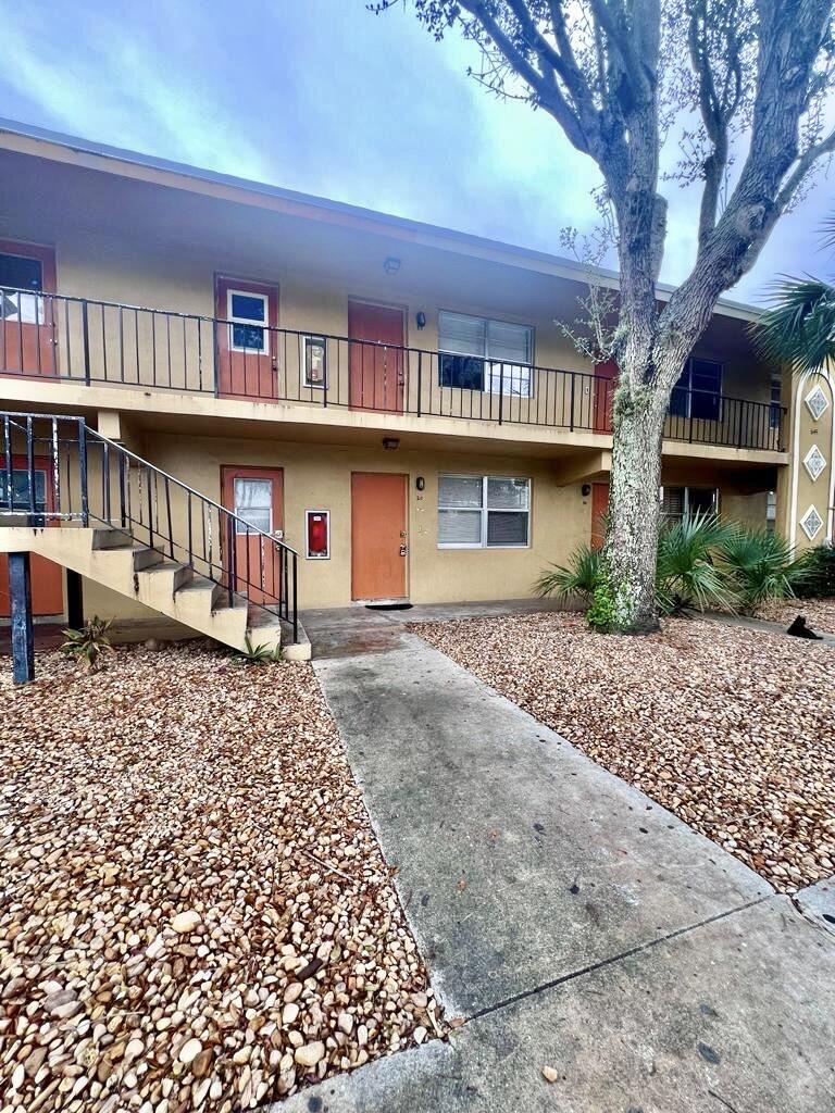 645 Southwest 20th Court, Unit 20 Delray Beach, FL 33445 - Photo 16 of 18 a front view of a house with a yard