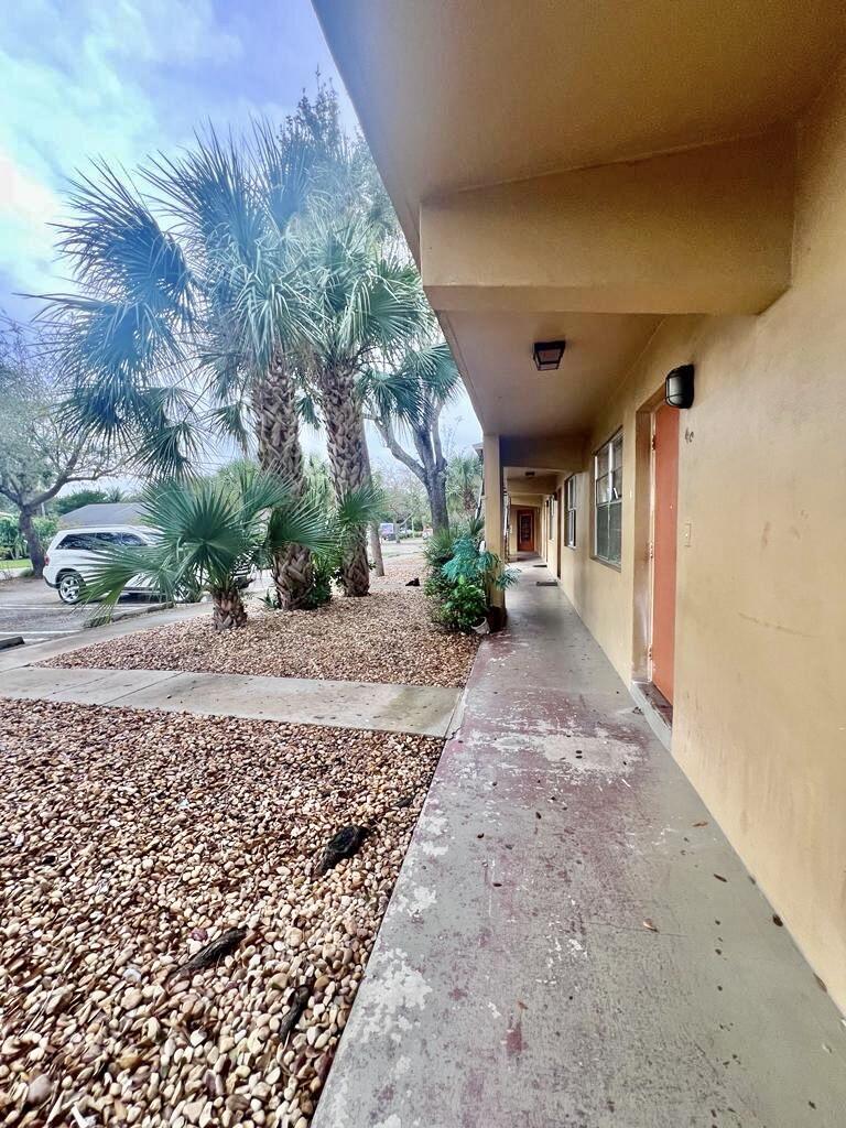 645 Southwest 20th Court, Unit 20 Delray Beach, FL 33445 - Photo 17 of 18 a view of a yard with plants and trees