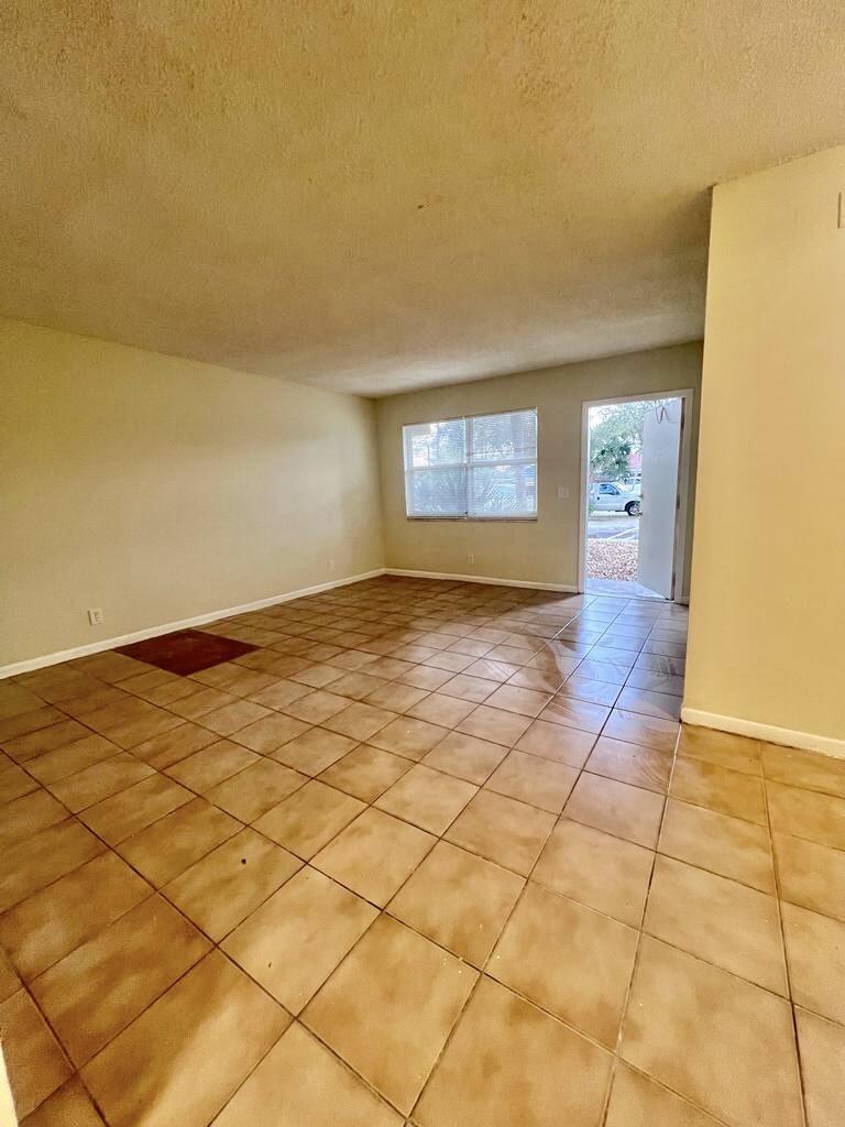 645 Southwest 20th Court, Unit 20 Delray Beach, FL 33445 - Photo 3 of 18 a view of an empty room and window