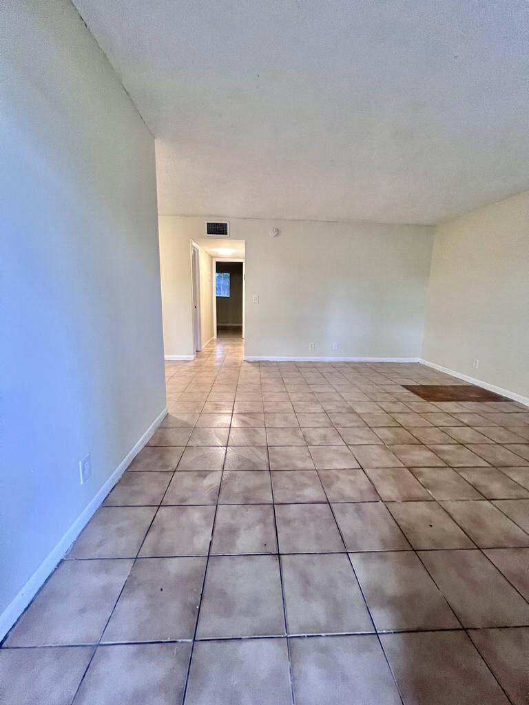 645 Southwest 20th Court, Unit 20 Delray Beach, FL 33445 - Photo 5 of 18 a view of a livingroom with an empty space and a window