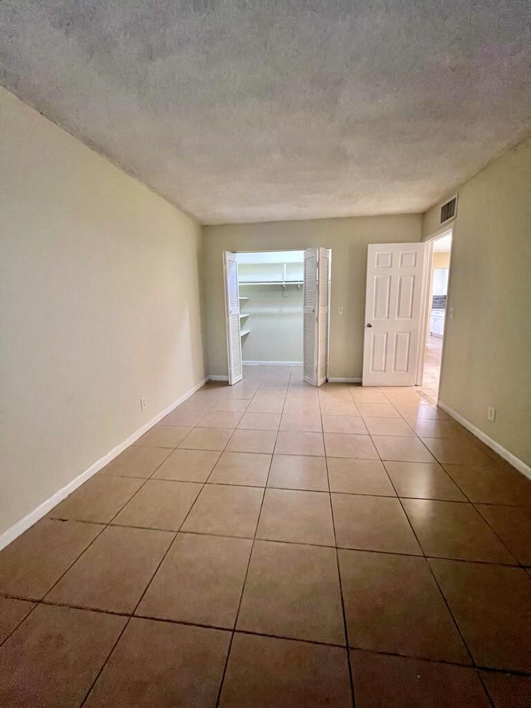 645 Southwest 20th Court, Unit 20 Delray Beach, FL 33445 - Photo 8 of 18 a view of an empty room with a window