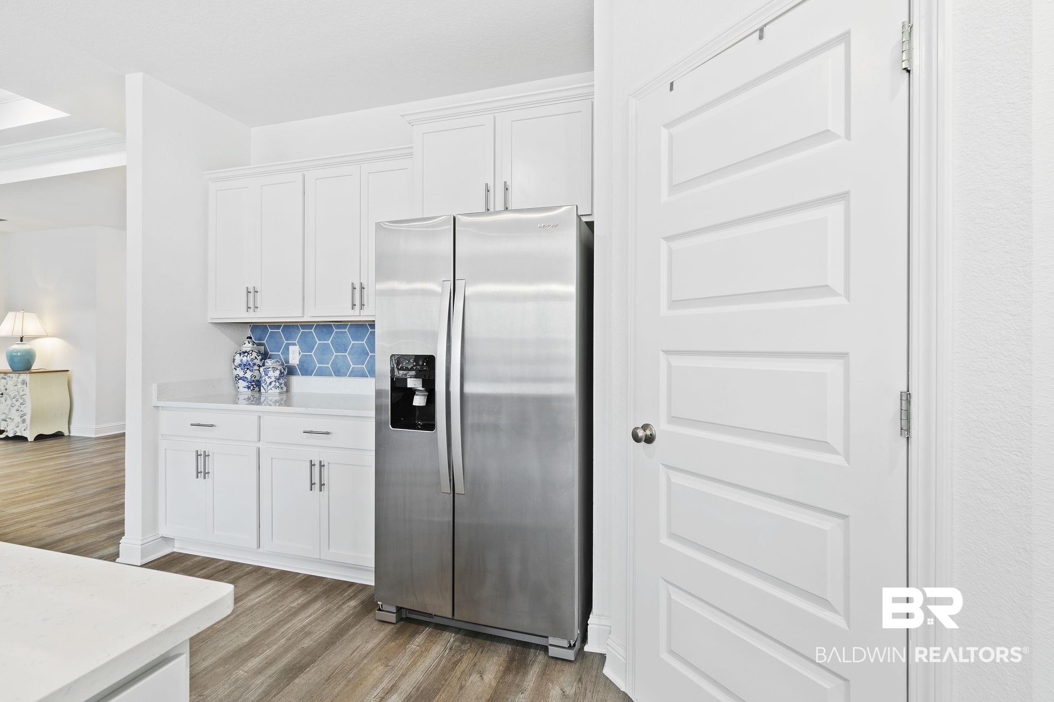 1141 Pencarro Boulevard Foley, AL 36535 - Photo 22 of 70 Kitchen with backsplash, stainless steel fridge, light hardwood / wood-style flooring, and white cabinets