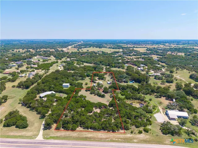 an aerial view of residential houses with city view