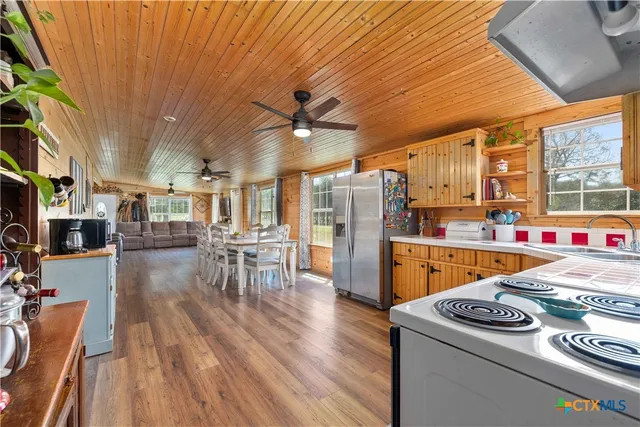 a kitchen that has a table chairs and wooden floor