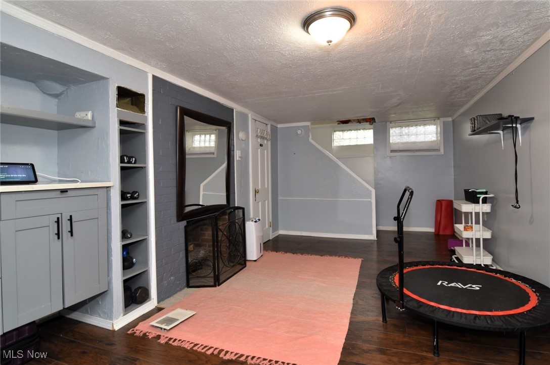 3921 Grosvenor Road Cleveland, OH 44118 - Photo 38 of 46 Playroom with a textured ceiling, built in shelves, and wood finished floors
