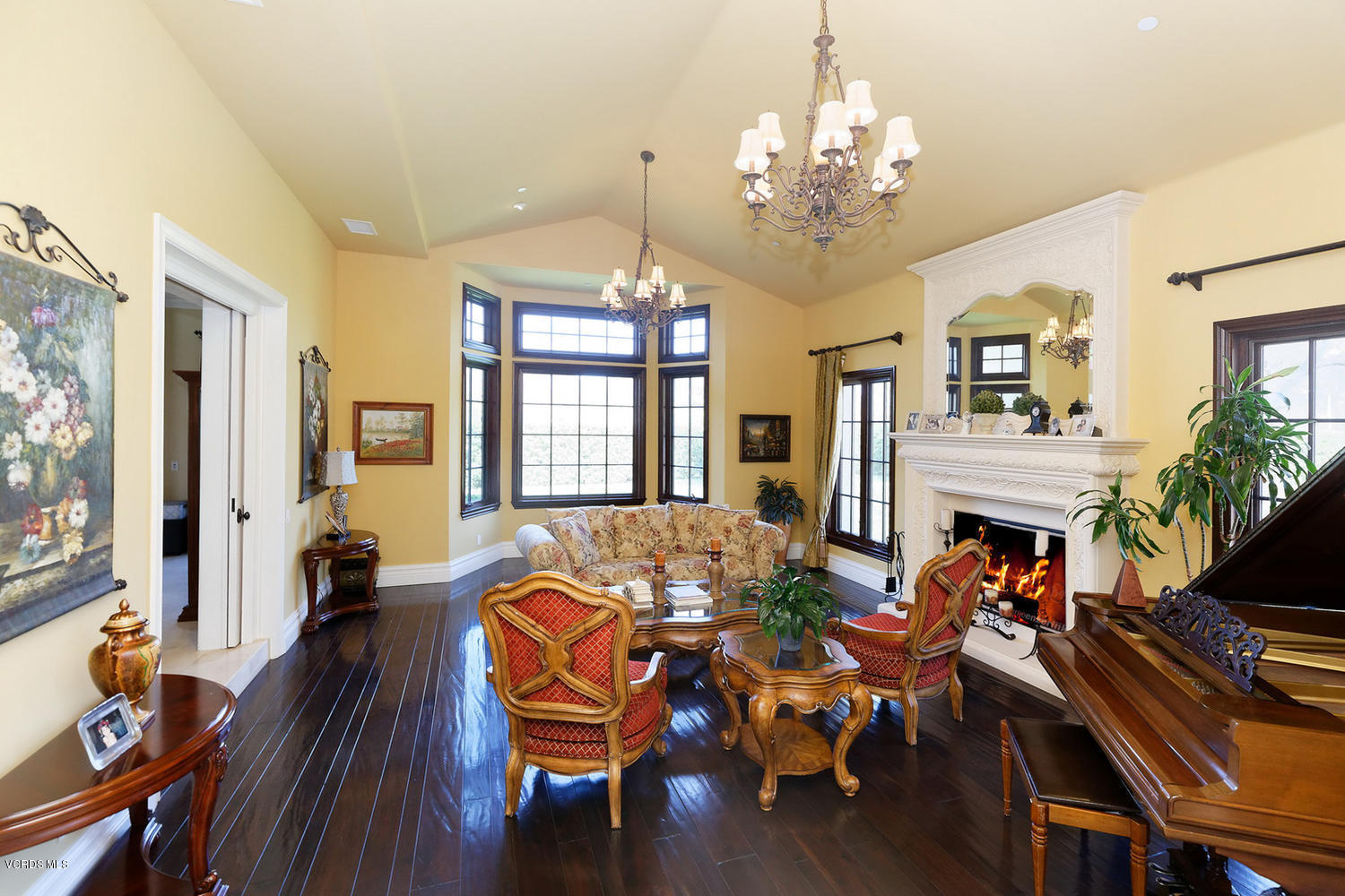 110 West Potrero Road Thousand Oaks, CA 91361 - Photo 8 of 33 a living room with fireplace furniture dining table and a chandelier