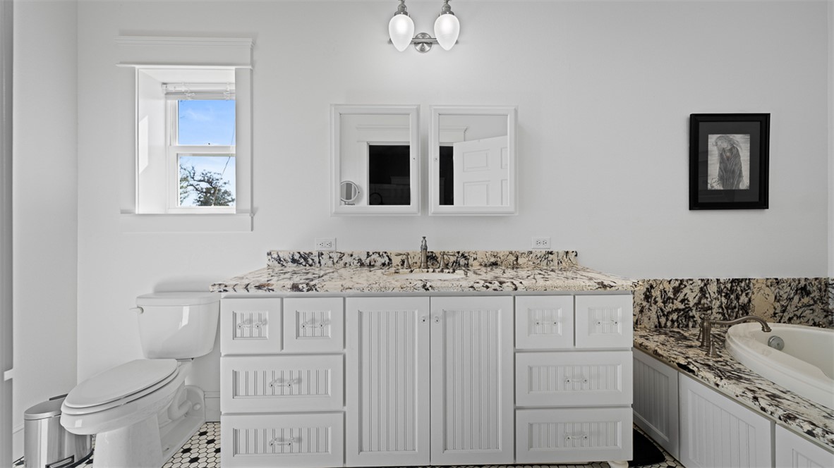 11258 Providence Road Hearne, TX 77859 - Photo 14 of 39 a bathroom with a sink a toilet and a mirror