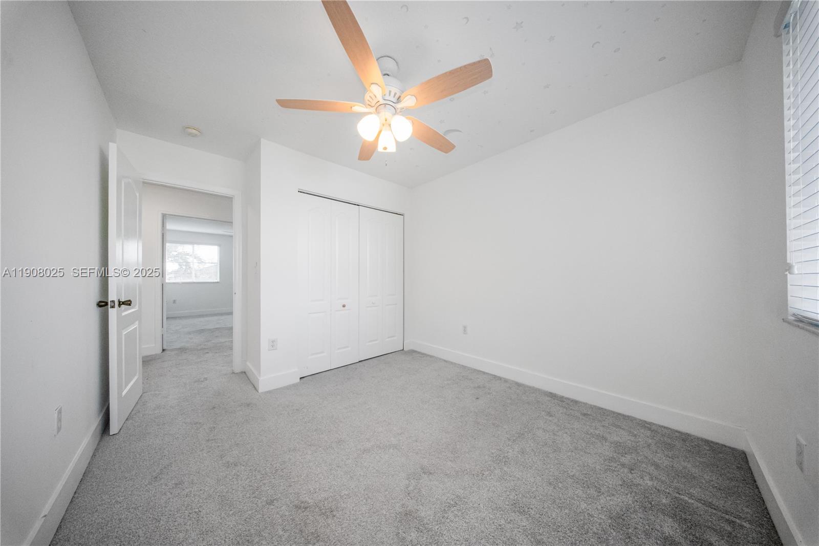 13868 Southwest 38th Terrace Miami, FL 33175 - Photo 19 of 30 an empty room with closet and a chandelier fan