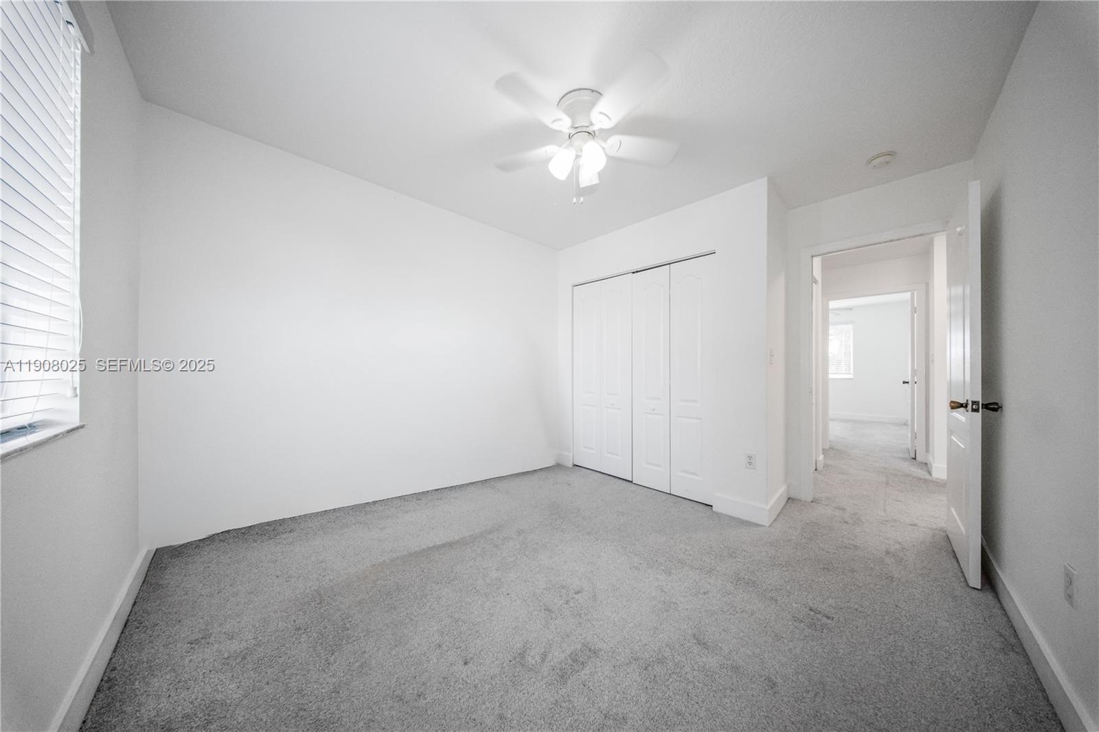 13868 Southwest 38th Terrace Miami, FL 33175 - Photo 21 of 30 an empty room with chandelier fan and windows