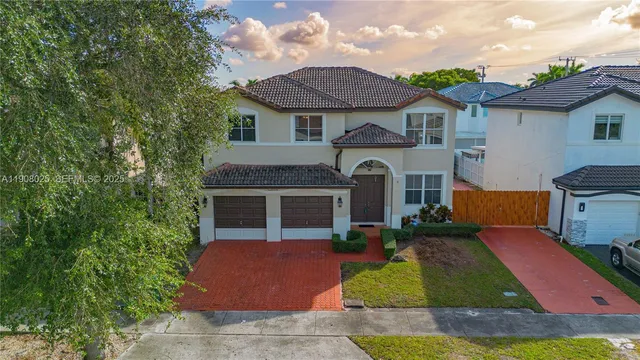 a front view of a house with yard and green space
