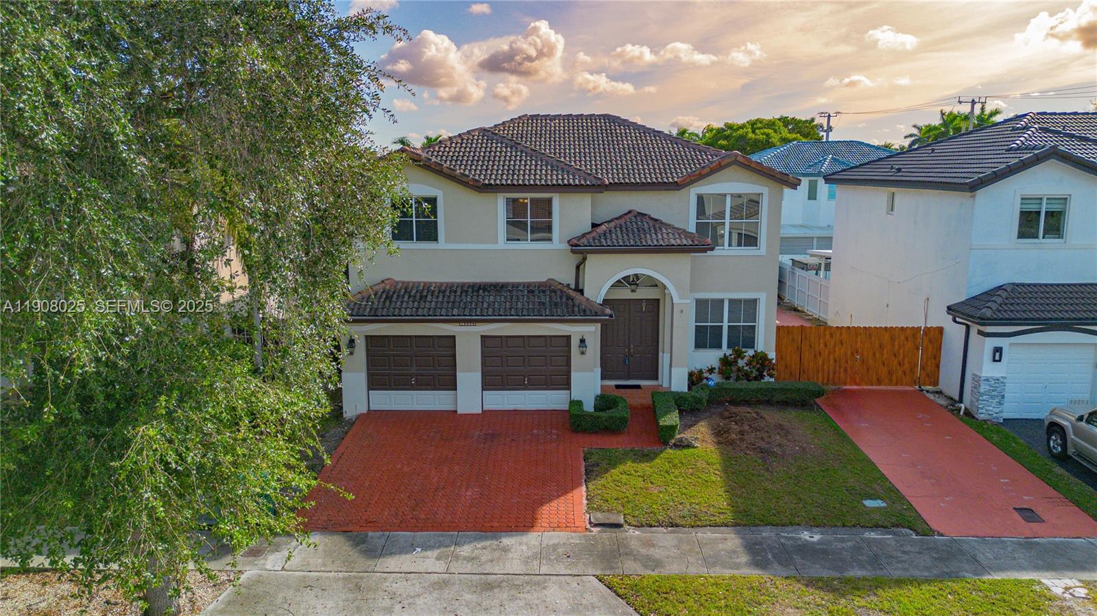 13868 Southwest 38th Terrace Miami, FL 33175 - Photo 27 of 30 a front view of a house with yard and green space
