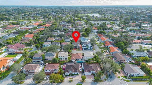an aerial view of a houses with a swimming pool