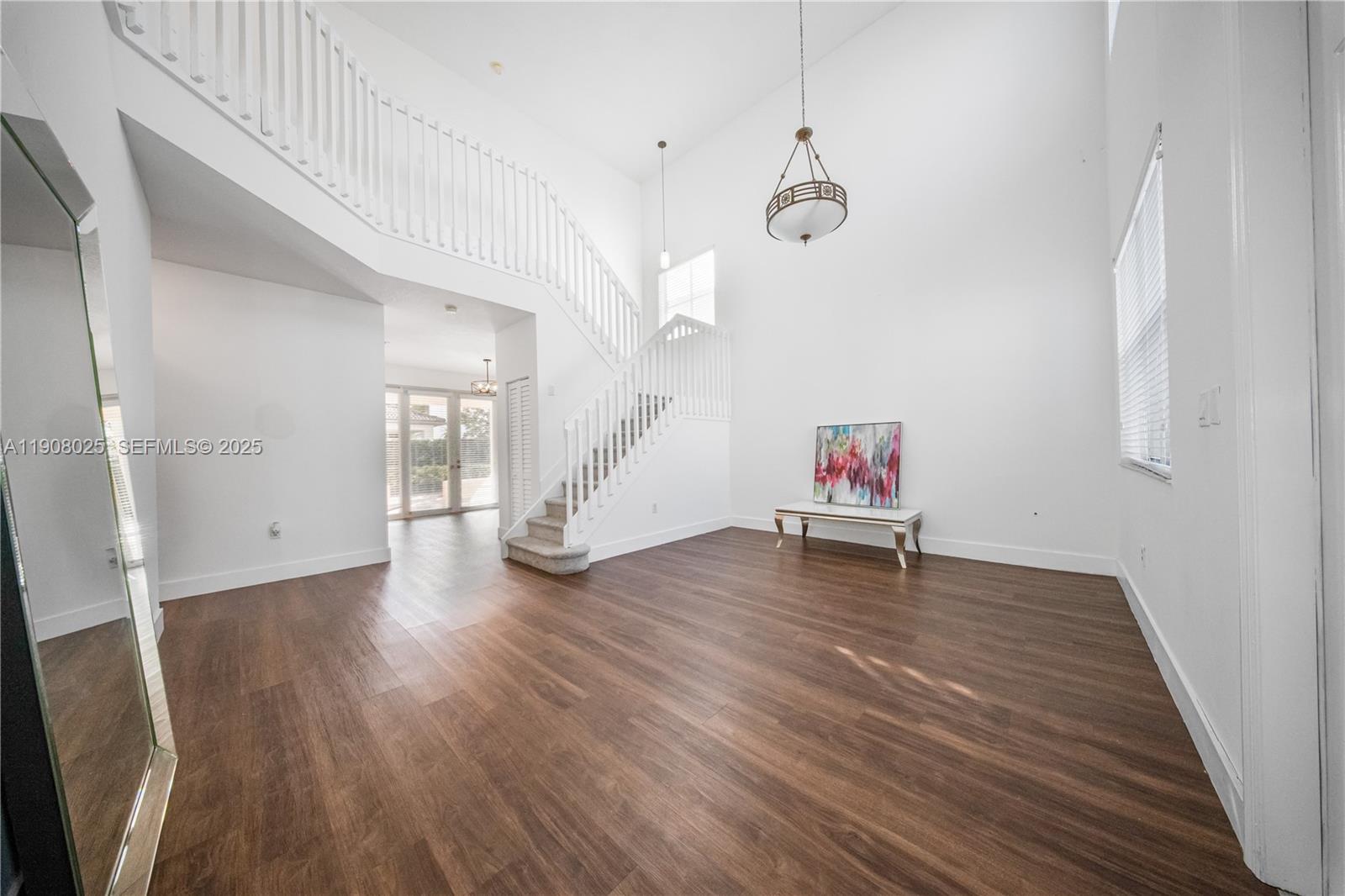 13868 Southwest 38th Terrace Miami, FL 33175 - Photo 3 of 30 an empty room with wooden floor and windows