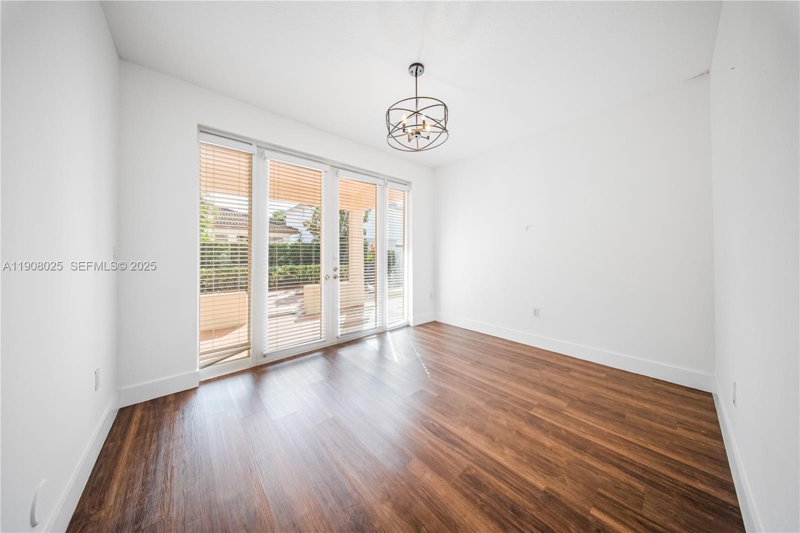 13868 Southwest 38th Terrace Miami, FL 33175 - Photo 5 of 30 a view of an empty room with wooden floor and a window