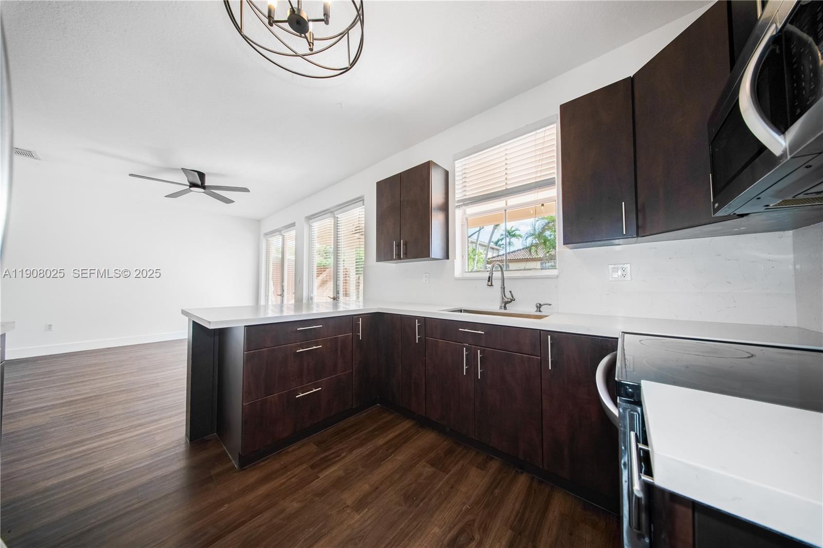 13868 Southwest 38th Terrace Miami, FL 33175 - Photo 6 of 30 a kitchen with wooden cabinets and a sink