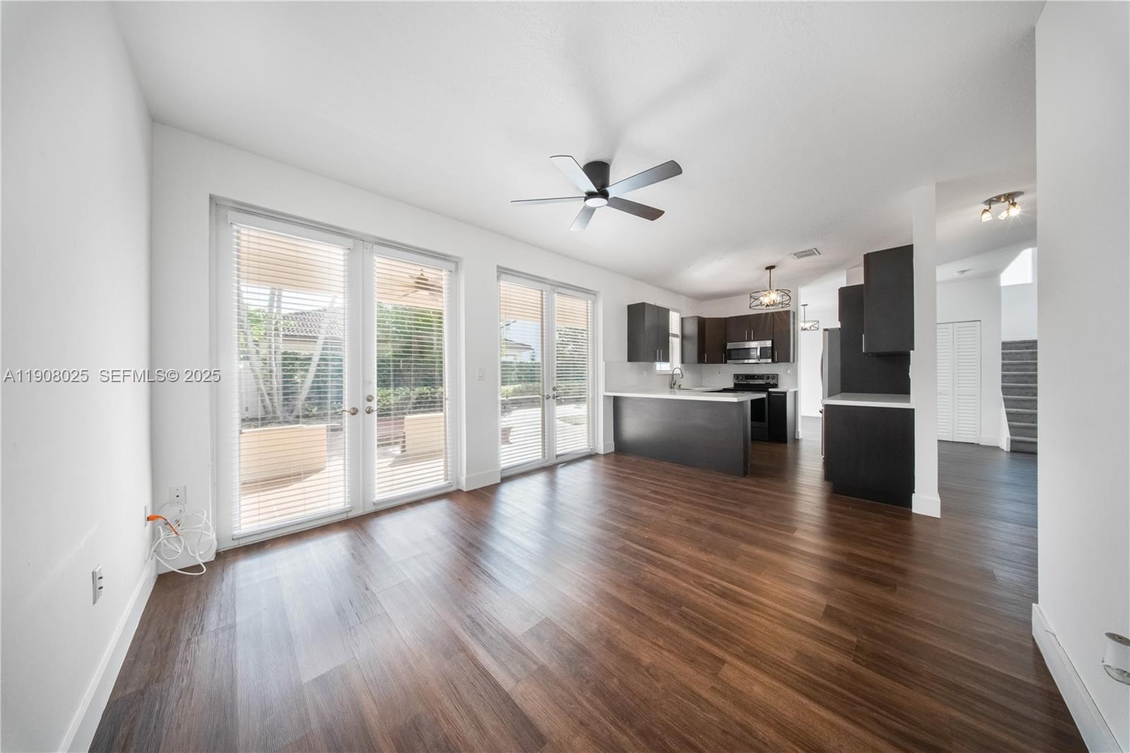13868 Southwest 38th Terrace Miami, FL 33175 - Photo 8 of 30 a view of a kitchen with a stove cabinets and a wooden floor