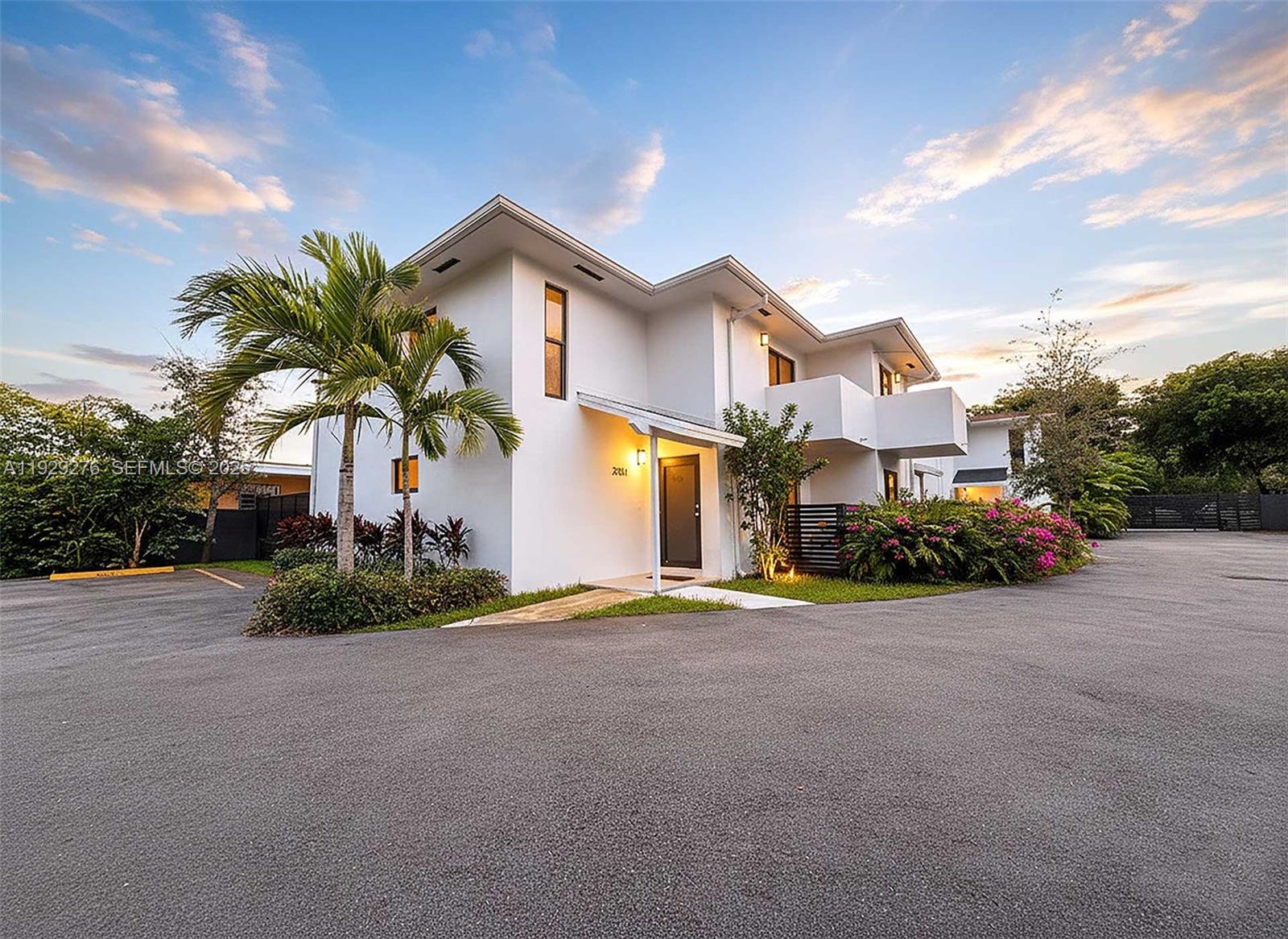 3079 Northwest 11th Street, Unit 3053 Miami, FL 33125 - Photo 11 of 11 a front view of a house with a garden and garage