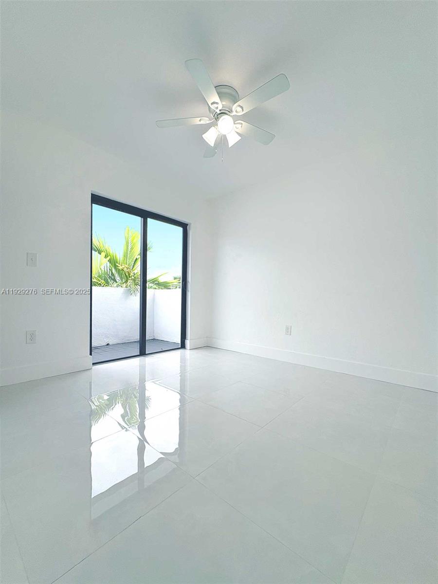 3079 Northwest 11th Street, Unit 3053 Miami, FL 33125 - Photo 3 of 11 a view of an empty room with a window