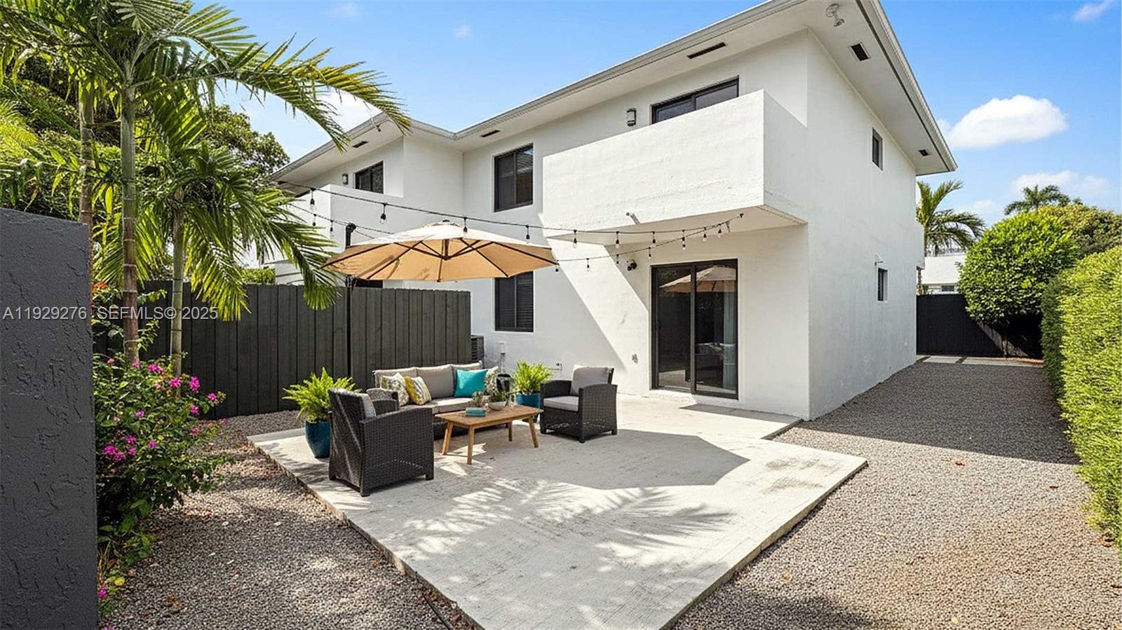 3079 Northwest 11th Street, Unit 3053 Miami, FL 33125 - Photo 5 of 11 a view of a patio with furniture and potted plants