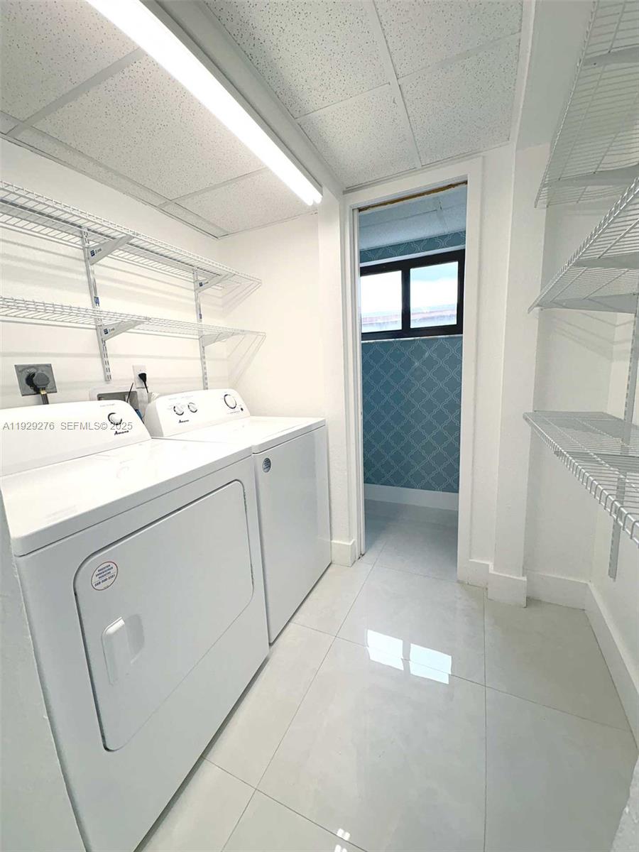 3079 Northwest 11th Street, Unit 3053 Miami, FL 33125 - Photo 7 of 11 a utility room with dryer and washer